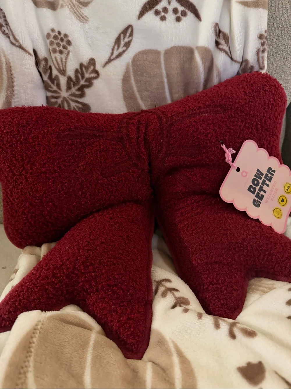 Burgundy bow-shaped cushion
